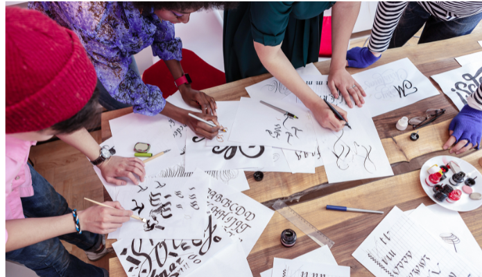 Students writing on a desk