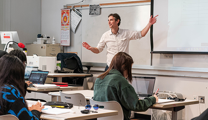 Image of teacher in front of classroom