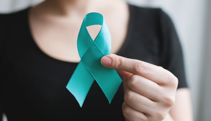 Woman holding teal ribbon