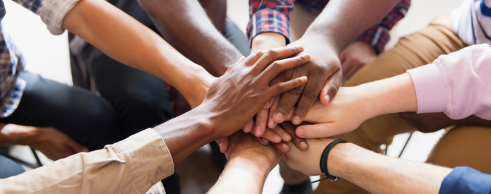 photo of many hands stacked together