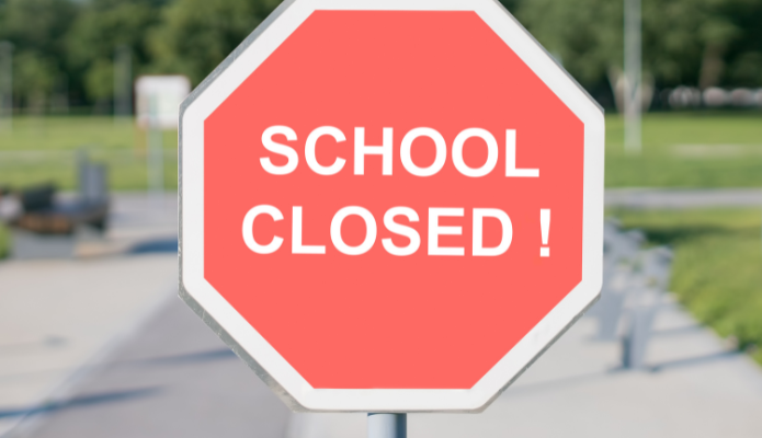 Red octagon sign with text "School Closed!"